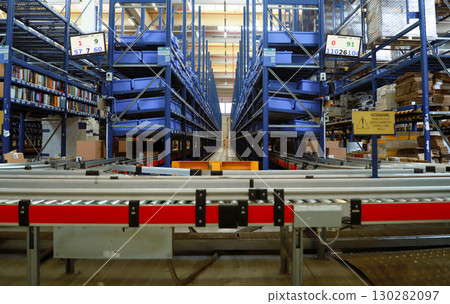 logistic warehouse. packing line in a logistics warehouse. conveyor belt in a modern production line logistic warehouse. packing line in a logistics warehouse. conveyor belt in a modern production line 130282097