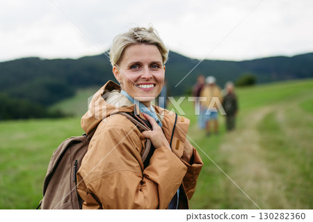 Portrait of beautiful woman during family hiking trip in nature. Portrait of beautiful woman during family hiking trip in nature. 130282360