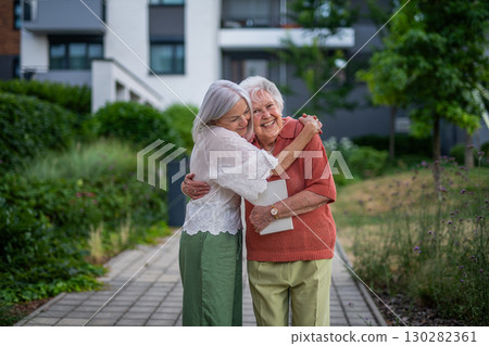 Portrait of beautiful adult daughter with old mother. 130282361