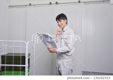 Workers looking at blueprints Warehouse Workers looking at blueprints Warehouse 130282423