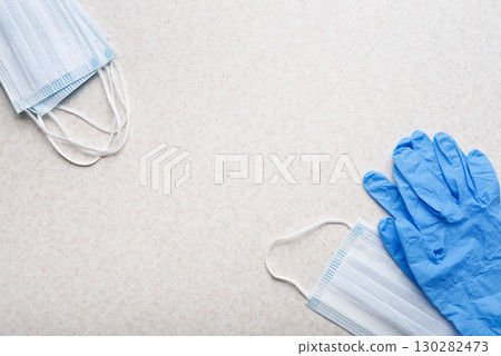 Medical face masks and single use gloves laying on table flat lay view Medical face masks and single use gloves laying on table flat lay view 130282473