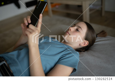 Stressed teenager checking her phone Stressed teenager checking her phone 130282514