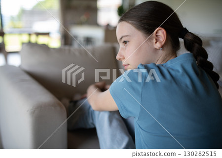 Teenage girl struggling with emotions in living room. 130282515