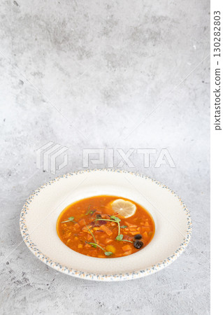 Traditional Georgian bean soup Lobio with herbs in ceramic plate 130282803