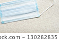 Medical single use face mask laying on table flat lay view 130282835