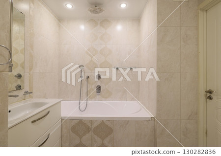 A Modern Bathroom featuring an Elegant Design complemented by a Relaxing Bathtub space 130282836