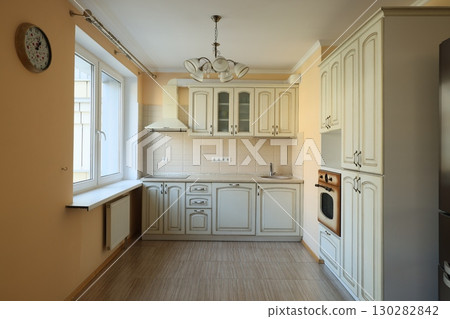 An Elegant and Modern Kitchen featuring Beautiful Cream Cabinets bathed in Natural Light An Elegant and Modern Kitchen featuring Beautiful Cream Cabinets bathed in Natural Light 130282842
