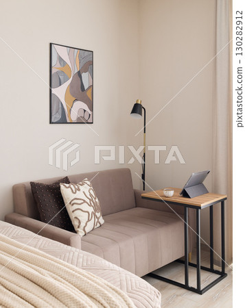 A Cozy and Modern Living Space That Features Art, Comfort, and a Functional Workspace A Cozy and Modern Living Space That Features Art, Comfort, and a Functional Workspace 130282912
