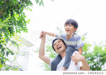Family: Boy being carried on his father's back 130283212