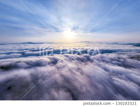 Amazing Sunrise over mountains hills covered with mist, Aerial view landscape drone shot beautiful sky colorful light nature background Amazing Sunrise over mountains hills covered with mist, Aerial view landscape drone shot beautiful sky colorful light nature background 130283321