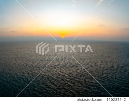 Aerial view sunset sky, Beautiful Light Sunset or sunrise over sea,Colorful dramatic majestic scenery sunset Sky, Amazing clouds and small waves in the ocean, Wonderful light cloud background Aerial view sunset sky, Beautiful Light Sunset or sunrise over sea,Colorful dramatic majestic scenery sunset Sky, Amazing clouds and small waves in the ocean, Wonderful light cloud background 130283342