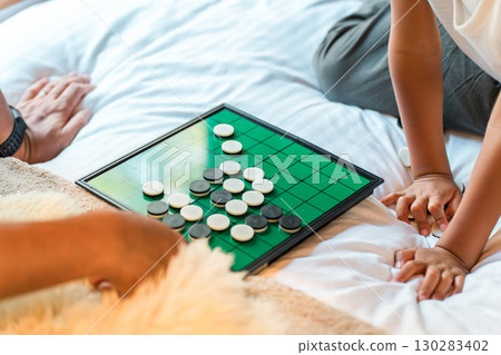 Hands playing Othello in the bedroom 130283402