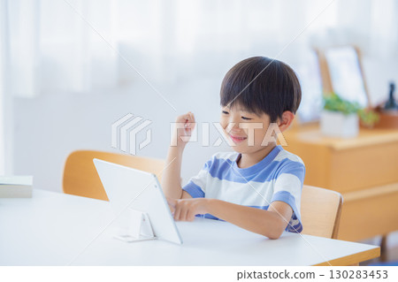 Boy studying on a tablet 130283453