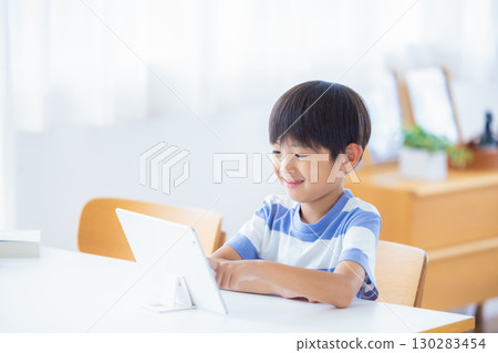 Boy studying on a tablet 130283454