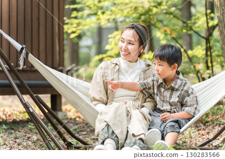 Family/family playing in a hammock at a campsite (outdoor/travel/leisure/picnic) 130283566