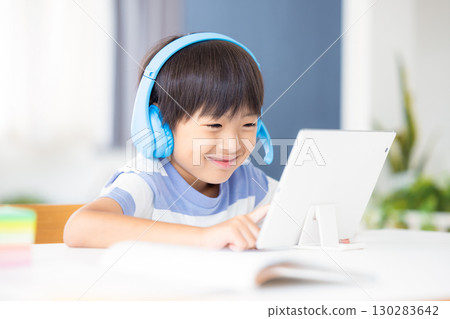 Boy studying on a tablet 130283642