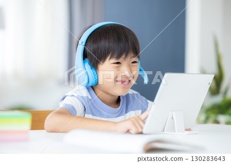 Boy studying on a tablet 130283643