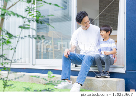 Family: Father and son relaxing in the garden Family: Father and son relaxing in the garden 130283667