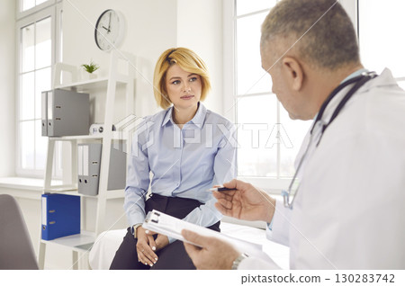 Female mature patient visiting a doctor at the medical office during medical examination. 130283742