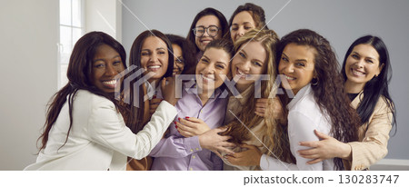 Banner with team of happy beautiful diverse multiracial women hugging and smiling Banner with team of happy beautiful diverse multiracial women hugging and smiling 130283747