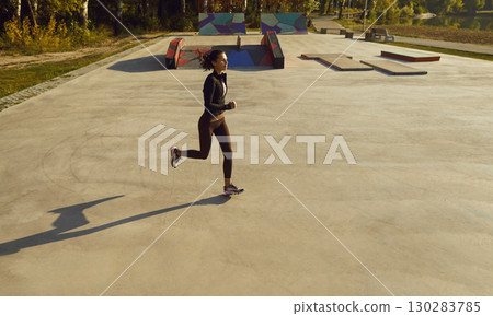 Top view of sporty woman running in a city park. Girl in sportswear jogging outdoor 130283785