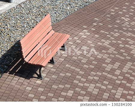 A bench in the courtyard bathed in the summer sunshine A bench in the courtyard bathed in the summer sunshine 130284100