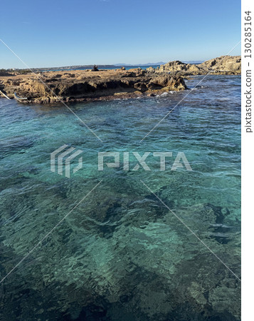 Rocky coastline and turquoise waters in Ibiza 130285164
