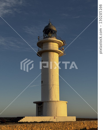Lighthouse at sunset on Ibiza coastline 130285166