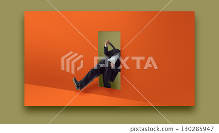 Bold colorful poster. Collage of businessman pulled by tie through doorway on orange wall with dramatic emotion Bold colorful poster. Collage of businessman pulled by tie through doorway on orange wall with dramatic emotion 130285947