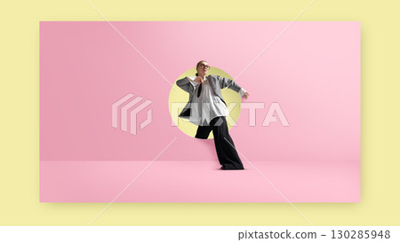 Contemporary collage. Businesswoman stepping through round doorway on pink wall with stylish oversized outfit and confident pose 130285948