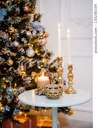 New Year's candles and a Christmas tree in the lights. 130286104