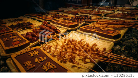 Chengdu, Sichuan, China. Various cooked insects thread on skewers. Insects on sticks at local Chinese market, close-up view. New Source Of Protein, Lipids, Minerals, And Vitamins. Fried Insects 130286133