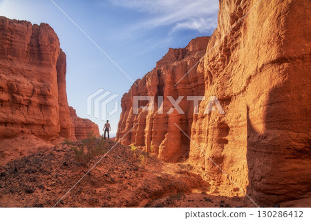 A solitary hiker stands at the stunning and majestic Red Rock Canyon  130286412