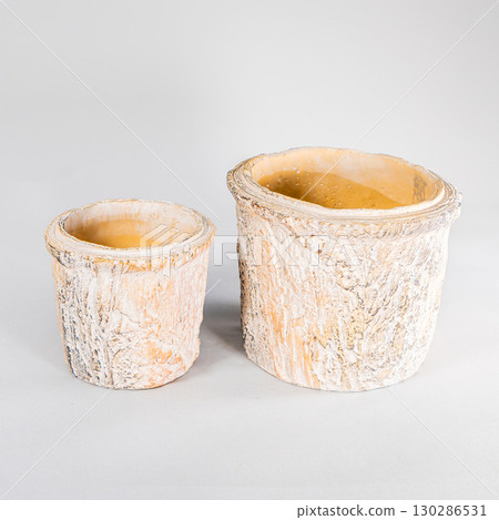 Clay flower pots isolated on white background, different sizes stacked Clay flower pots isolated on white background, different sizes stacked 130286531