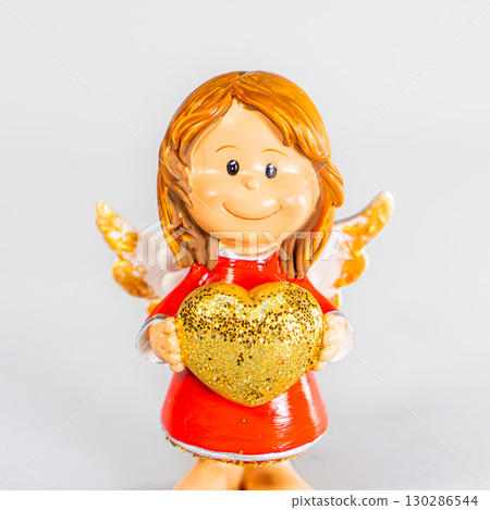 angel statue isolated on white background. Figurine of an angel on a white background. Ceramic angel isolated. 130286544