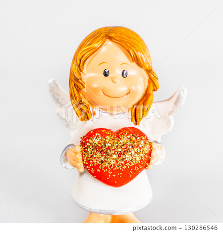 angel statue isolated on white background. Figurine of an angel on a white background. Ceramic angel isolated. angel statue isolated on white background. Figurine of an angel on a white background. Ceramic angel isolated. 130286546