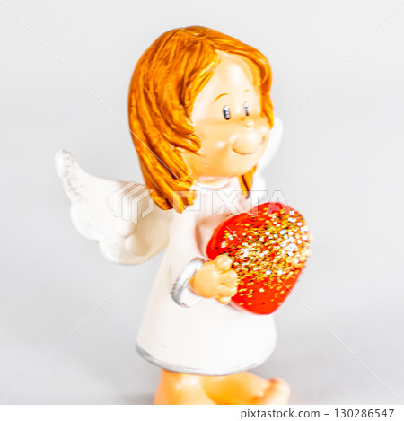 angel statue isolated on white background. Figurine of an angel on a white background. Ceramic angel isolated. 130286547