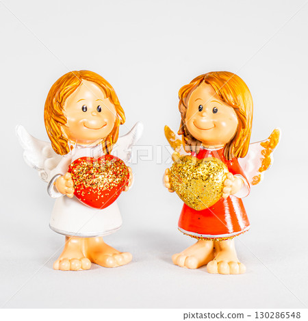 angel statue isolated on white background. Figurine of an angel on a white background. Ceramic angel isolated. 130286548