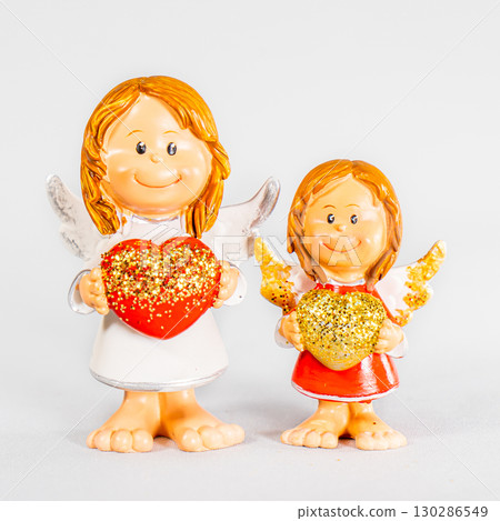 angel statue isolated on white background. Figurine of an angel on a white background. Ceramic angel isolated. 130286549