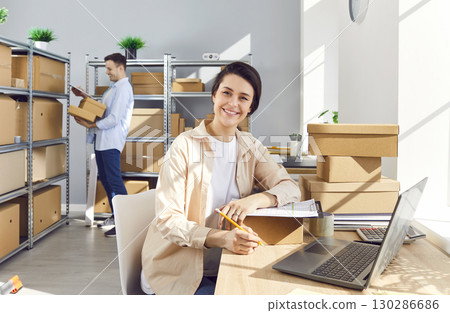 Portrait Of Businesswoman Working In Warehouse And Conducting Inventory 130286686