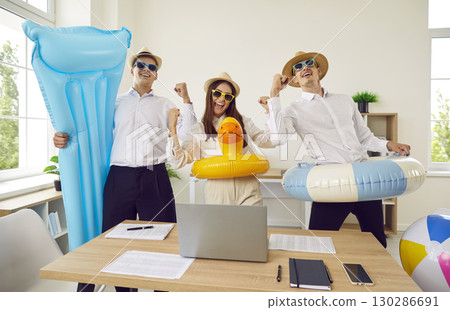 Happy corporate business team going on summer vacation and having fun in the office Happy corporate business team going on summer vacation and having fun in the office 130286691