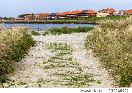 Natural beach with sand and grass in the town of Ronne on the Bornholm Island, Denmark Natural beach with sand and grass in the town of Ronne on the Bornholm Island, Denmark 130286922