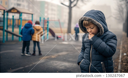 Child Coughing in Winter Coat at Foggy Playground 130287067