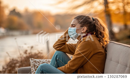 Young Woman Wearing Medical Mask Outdoors in Autumn Young Woman Wearing Medical Mask Outdoors in Autumn 130287069