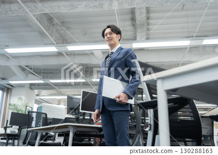 A young businessman working in the office 130288163