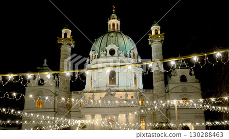 Night view of a festive Christmas market in front of Karlskirche church in Vienna, Austria 130288463