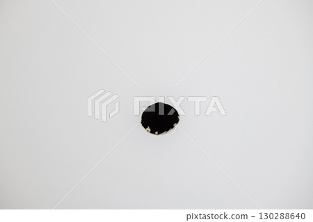 Minimalist detail of hole in white drywall background. empty abstract view part of house construction site shows specific moment during renovation project Minimalist detail of hole in white drywall background. empty abstract view part of house construction site shows specific moment during renovation project 130288640
