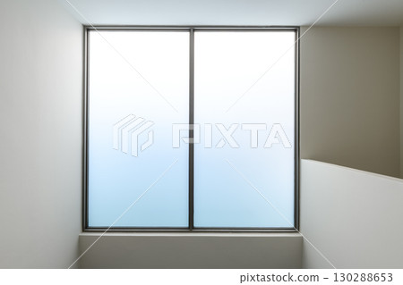 Minimalist frosted glass window detail in modern house during renovation. construction project features serene blue gradient light creating calm peaceful atmosphere Minimalist frosted glass window detail in modern house during renovation. construction project features serene blue gradient light creating calm peaceful atmosphere 130288653