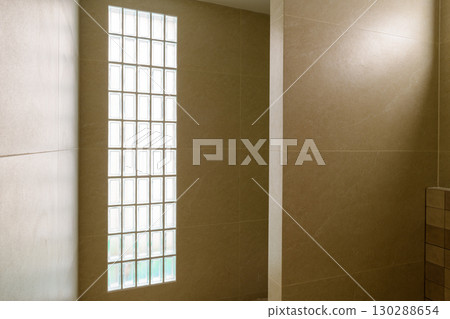 Peaceful house renovation project showing construction detail of modern bathroom with glass block window. minimalist interior architecture provides calm feeling Peaceful house renovation project showing construction detail of modern bathroom with glass block window. minimalist interior architecture provides calm feeling 130288654