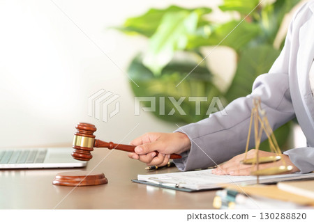 Legal Authority. Lawyer striking gavel in office, emphasizing decision-making. Legal Authority. Lawyer striking gavel in office, emphasizing decision-making. 130288820